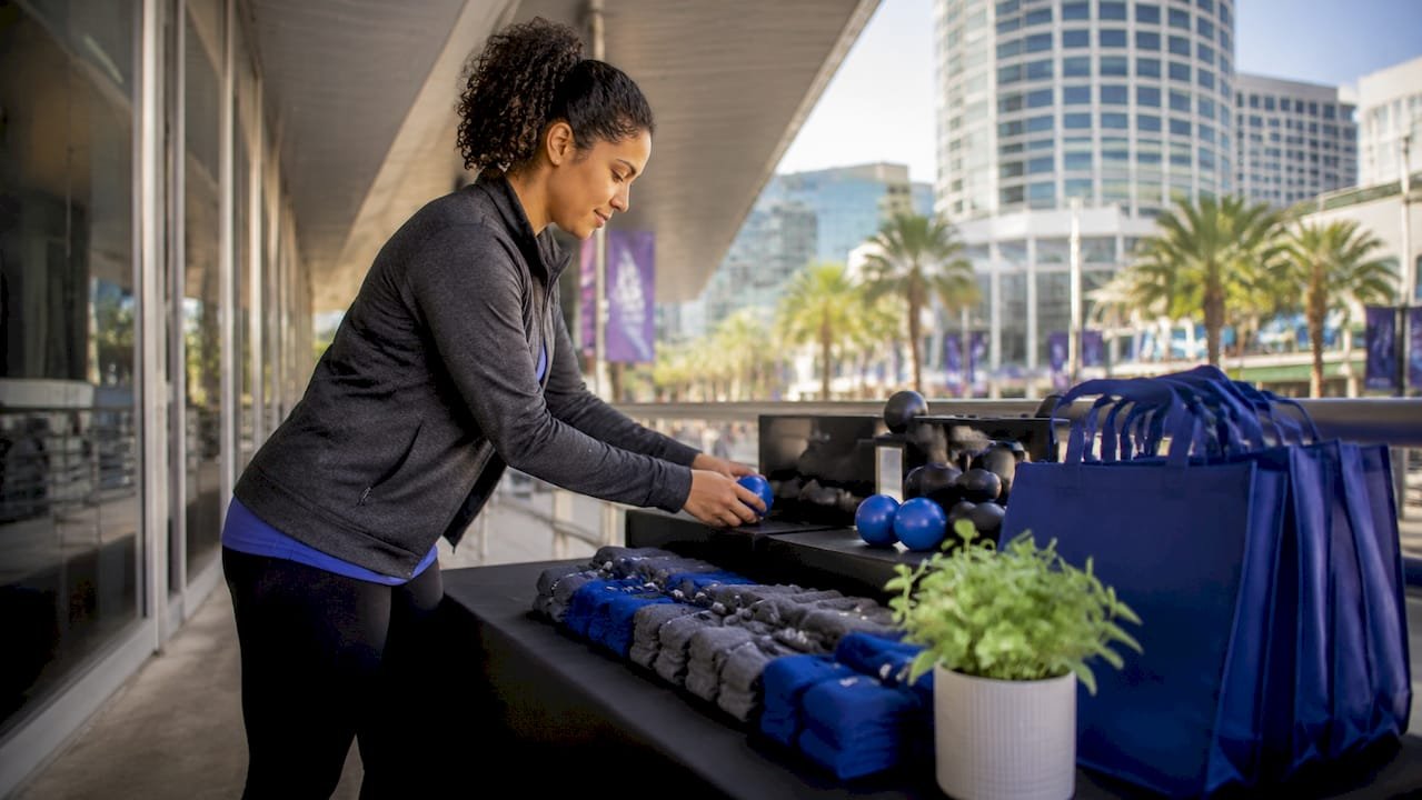 Event manager arranging tiered promo items on table