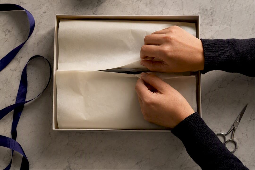 Hands finishing premium gift box packaging