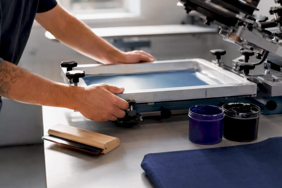 Technician preparing a screen printing press
